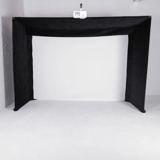 Black golf simulator enclosure with projector mounted above white impact screen for indoor practice