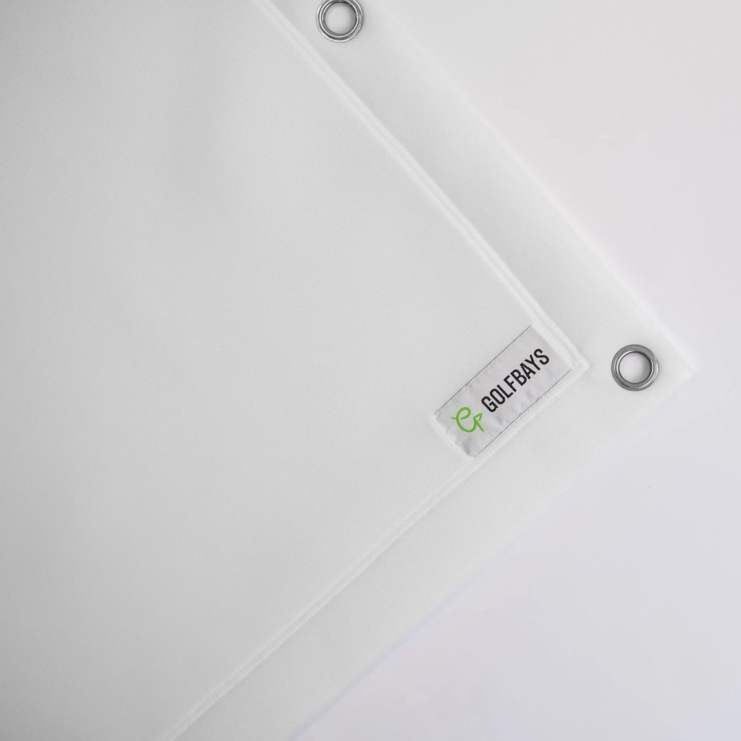 White golf simulator impact screen with GOLFBAYS logo and grommets for indoor setup