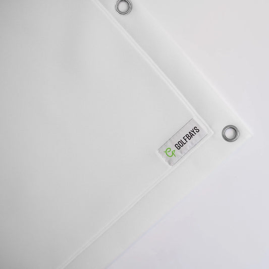 White golf simulator impact screen with GOLFBAYS logo and grommets for indoor setup