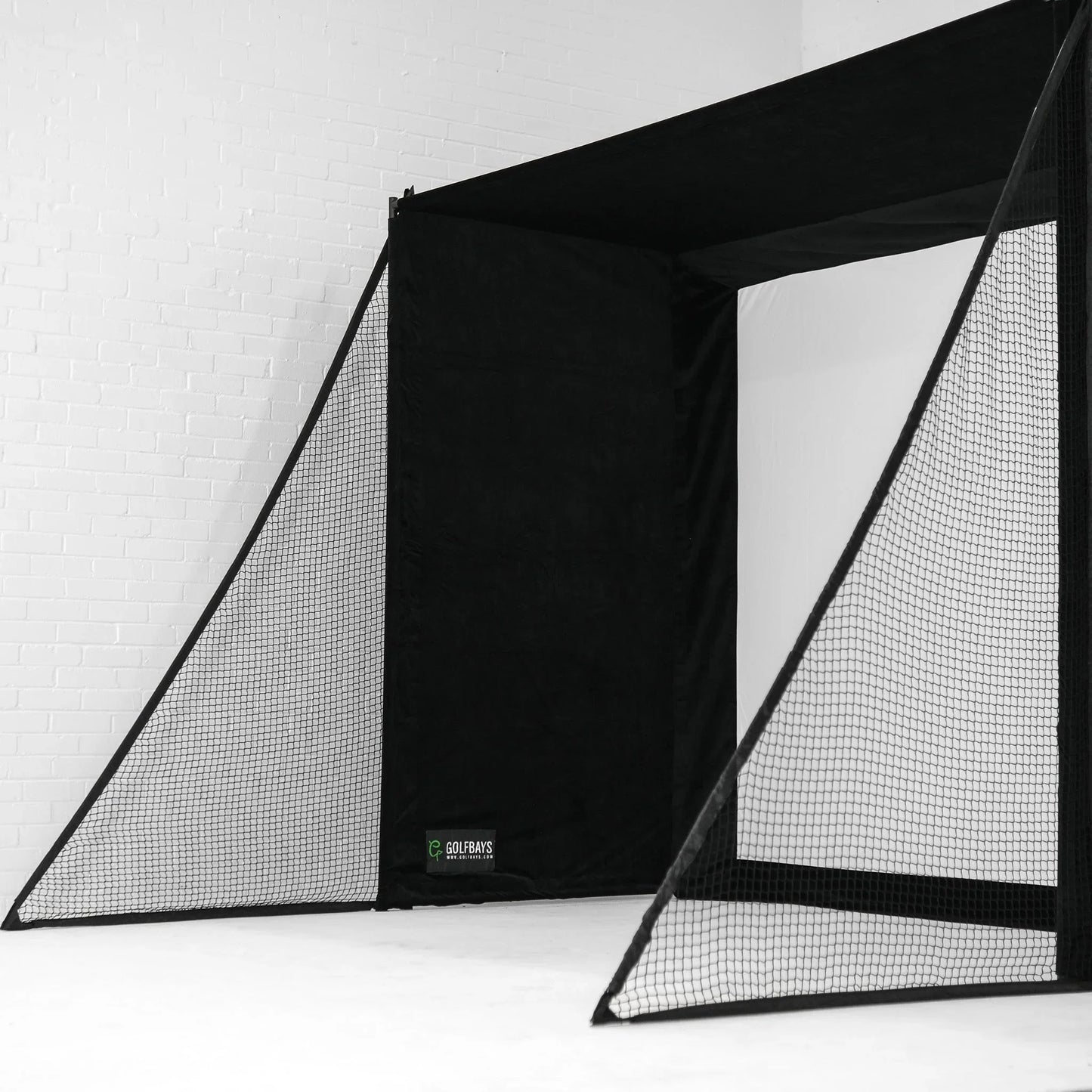 Black golf simulator enclosure with impact screen and netting for indoor practice