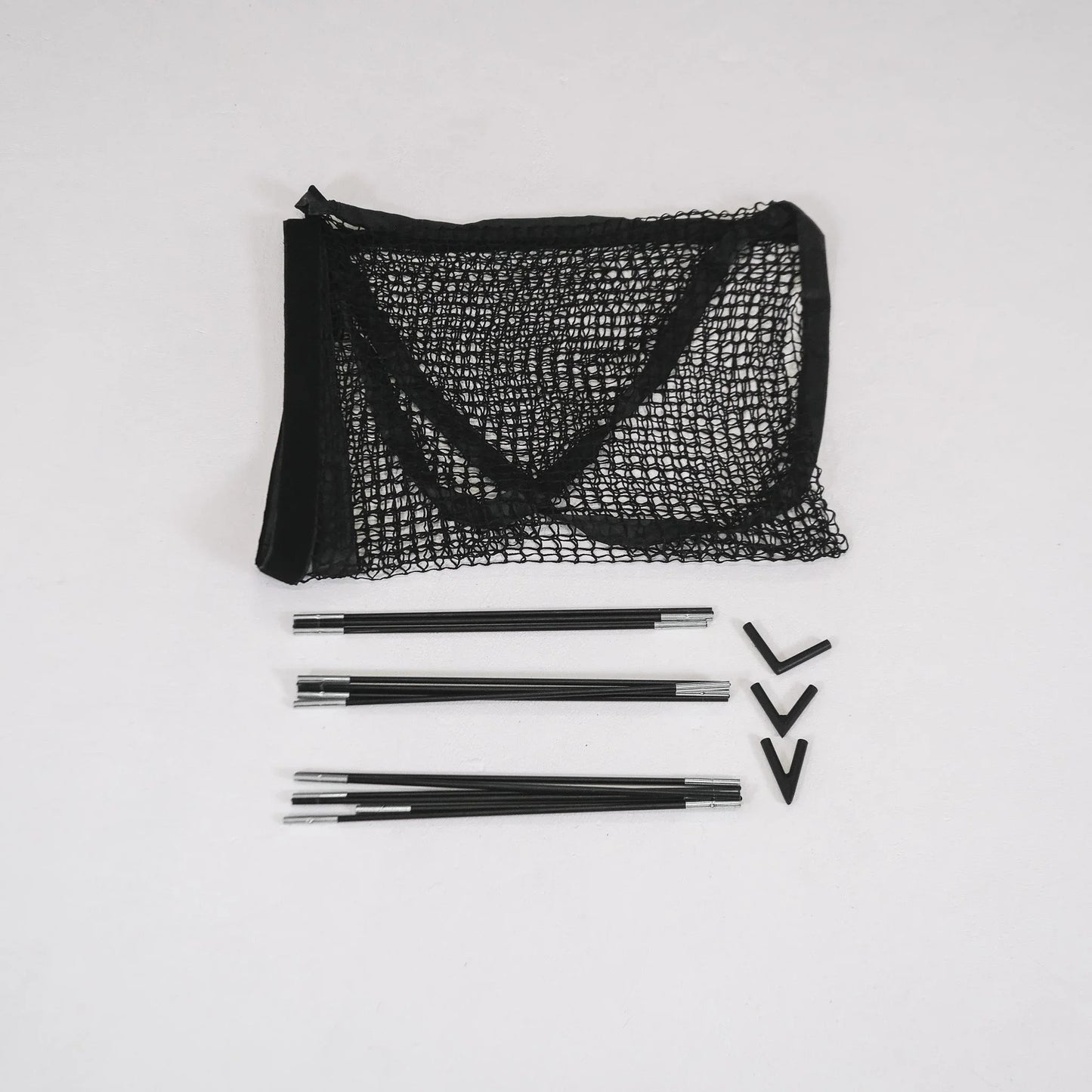 Black golf simulator net with frame poles and connectors for indoor practice setup